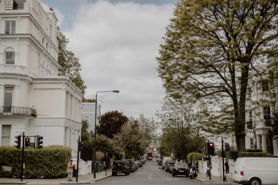 A city street scene in Wood Green, Haringey, featuring large white Victorian-style terraced buildings with ornate architectural details on the left, and residential apartments on the right, framed by 